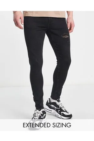 ASOS Jeans spray on power stretch slavato con abrasioni e fondo grezzo