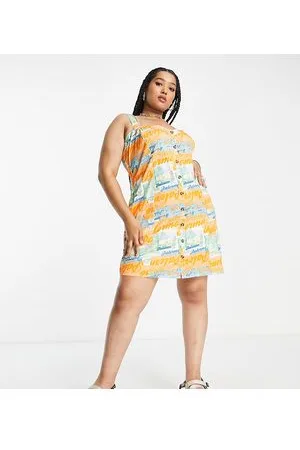 ASOS ASOS DESIGN Curve - Prendisole a canottiera in twill con stampa di cartoline