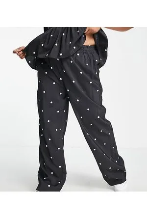 Pieces® Pieces Curve - Pantaloni a fondo ampio neri a pois in coordinato
