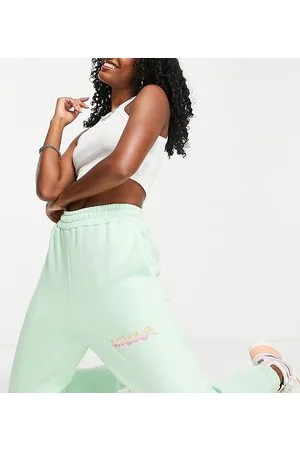 COLLUSION Joggers chiaro con logo distorto