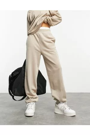 ASOS Joggers in tonalità neutrale slavata con logo "WCA"