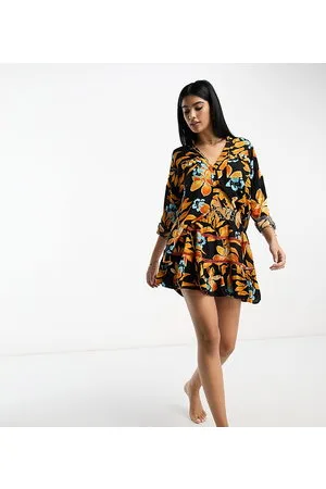River Island Minigonna da spiaggia arricciata nera con stampa tropicale in coordinato