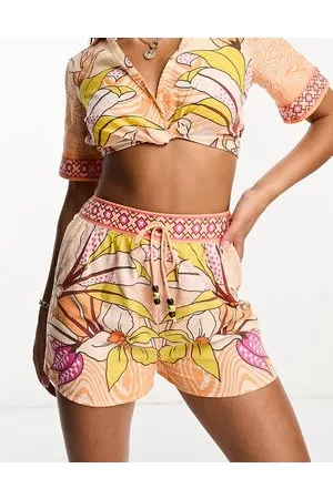 River Island Pantaloncini da mare arancioni con stampa tropicale in coordinato