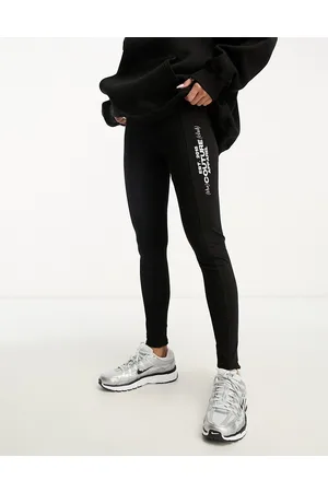 The Couture Club Leggings neri con stampe sulle gambe in coordinato