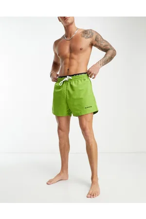 We Are We Wear Bobbie - Pantaloncini da bagno verdi lunghezza standard con fascia in vita con logo