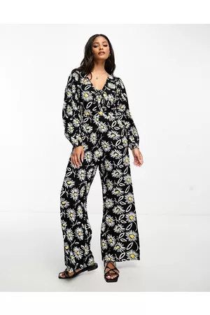 Influence Tuta jumpsuit monocromatica con stampa di margherite, allacciatura sul davanti e maniche a sbuffo