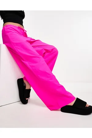 COLLUSION Pantaloni parachute a vita bassa con fondo ampio rosa acceso