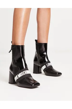 Moschino Stivali con tacco in pelle nera con logo