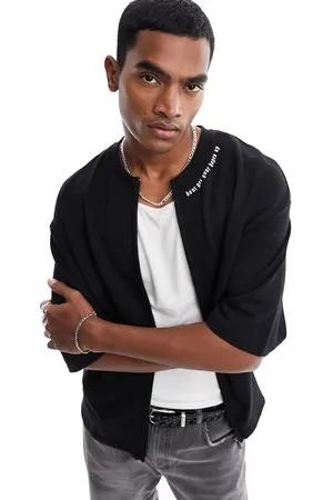 ADPT. T-shirt oversize nera pesante con stampa sul colletto e zip