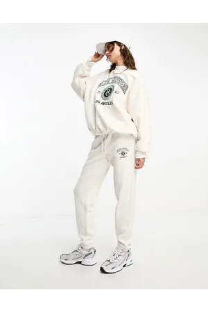 PACSUN Joggers slim color avena mélange con scritta stile college in coordinato