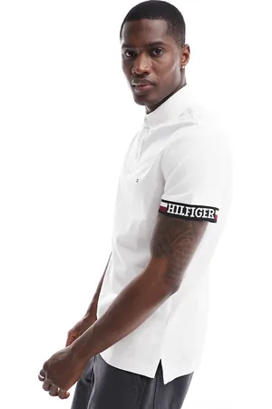 Tommy Hilfiger Polo slim fit bianca con logo della bandiera sul giromanica