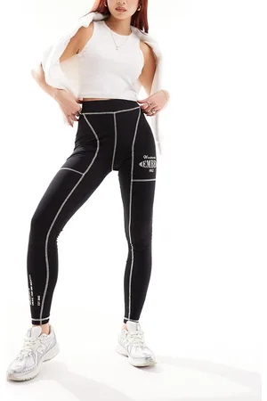 The Couture Club Leggings oversize neri con cuciture a contrasto e grafica