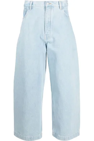 STUDIO NICHOLSON Jeans crop a gamba ampia