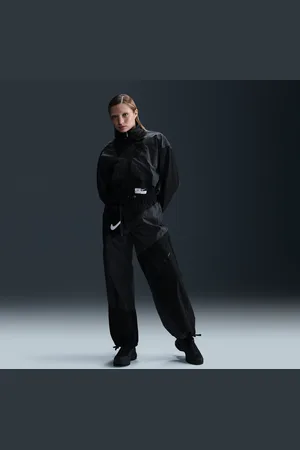 Nike Pantaloni a vita media in tessuto con bordo aperto Sportswear – Donna
