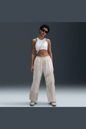 Nike Pantaloni a vita media in tessuto con bordo aperto Sportswear – Donna