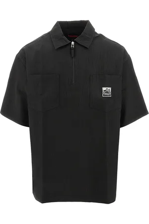Pleasures Polo con zip 